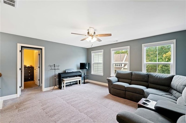 carpeted living room with ceiling fan