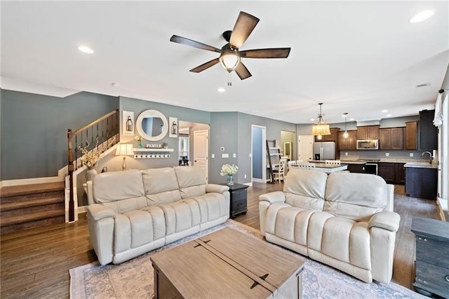 living room with ceiling fan and hardwood / wood-style flooring