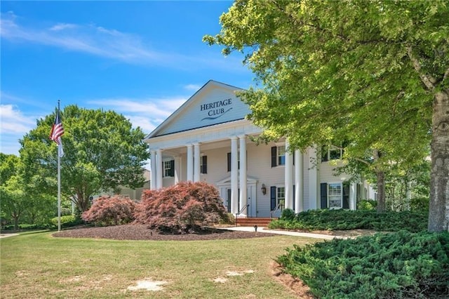 greek revival inspired property featuring a front yard