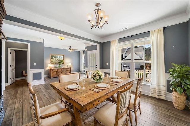 dining room featuring visible vents, wainscoting, crown molding, and hardwood / wood-style floors