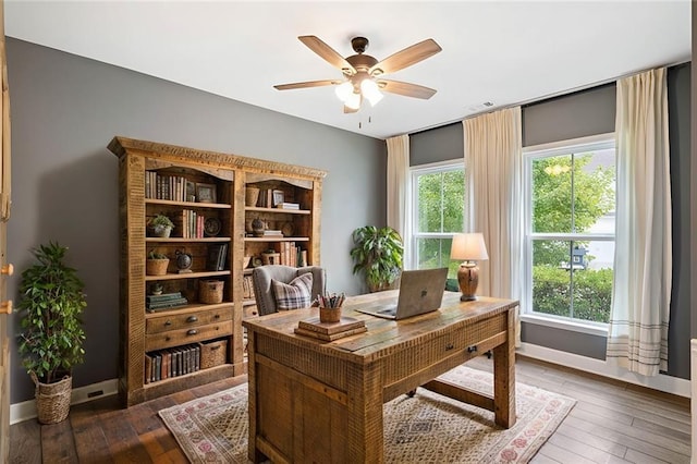 office area with ceiling fan and dark hardwood / wood-style floors