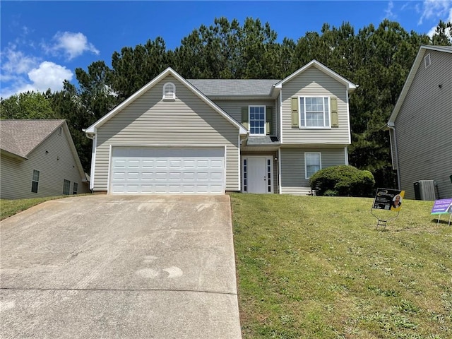 traditional home with a garage, driveway, and a front yard
