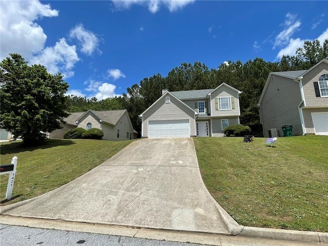 view of front of property with a front lawn, concrete driveway, and a garage