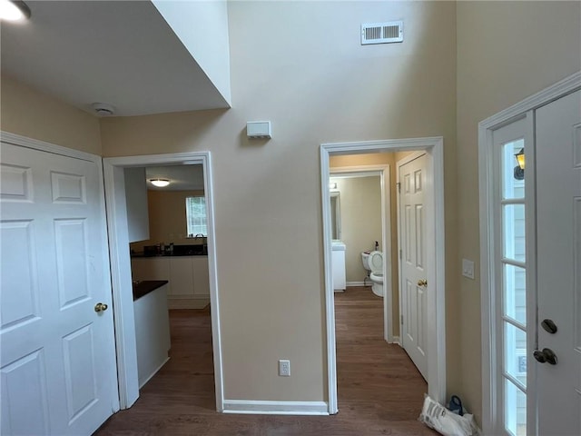 entryway with dark wood-type flooring and baseboards