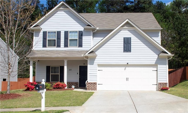traditional home with a front lawn, fence, and driveway
