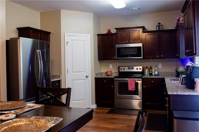 20 Autumn Canyon Path SE, Cartersville, GA 30121 - kitchen with appliances with stainless steel finishes, dark wood-type flooring, dark brown cabinetry, and light stone counters