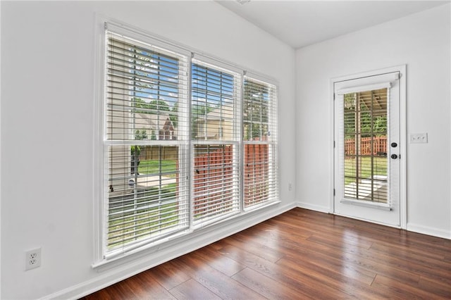 spare room with wood finished floors and baseboards