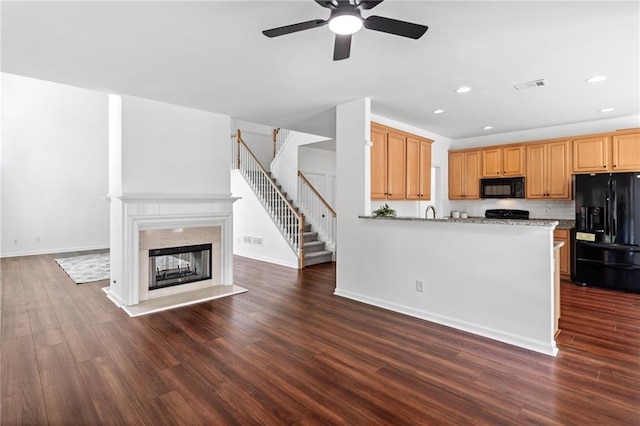 unfurnished living room featuring a ceiling fan, stairs, dark wood-style flooring, recessed lighting, and baseboards