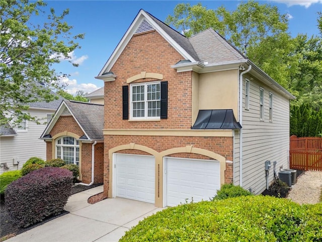 traditional-style home with driveway, a garage, central air condition unit, fence, and brick siding
