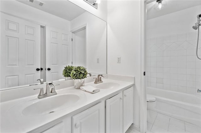 bathroom with toilet, double vanity, and shower / tub combination