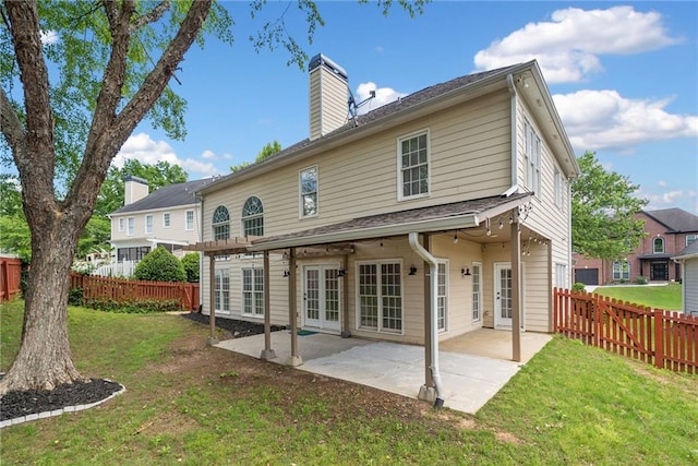 back of property featuring a chimney, a patio area, and french doors
