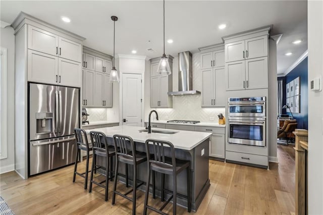 408 Townly Ct, Alpharetta, GA 30009 - kitchen featuring stainless steel appliances, wall chimney exhaust hood, a sink, light countertops, and a breakfast bar