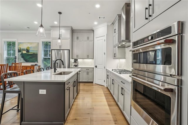 408 Townly Ct, Alpharetta, GA 30009 - kitchen featuring stainless steel appliances, a sink, wall chimney exhaust hood, crown molding, and gray cabinetry