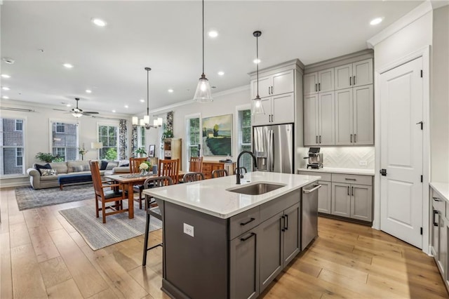 408 Townly Ct, Alpharetta, GA 30009 - kitchen featuring stainless steel appliances, gray cabinetry, a sink, crown molding, and light countertops