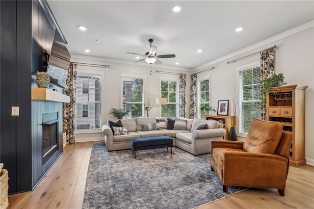 408 Townly Ct, Alpharetta, GA 30009 - living area featuring light wood finished floors, crown molding, a ceiling fan, a fireplace, and recessed lighting