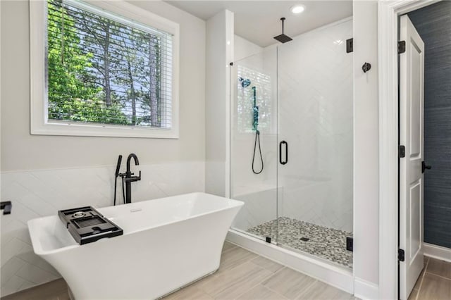 408 Townly Ct, Alpharetta, GA 30009 - bathroom featuring tile walls, a shower stall, a freestanding bath, recessed lighting, and wainscoting