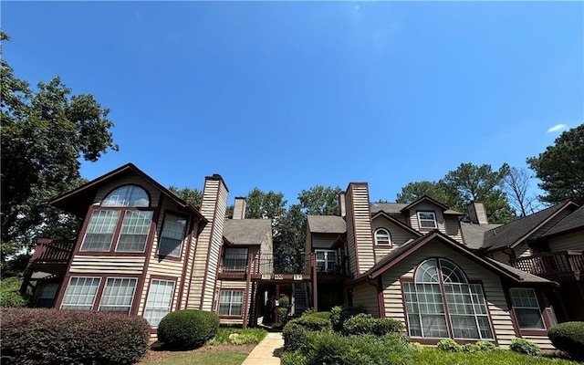 view of front of house featuring a chimney and a wooden deck