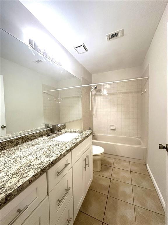 bathroom featuring tile patterned flooring, visible vents, shower / tub combination, and toilet