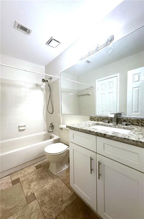 bathroom featuring toilet, washtub / shower combination, visible vents, and vanity