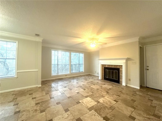 unfurnished living room with ornamental molding, a ceiling fan, a textured ceiling, a tile fireplace, and baseboards