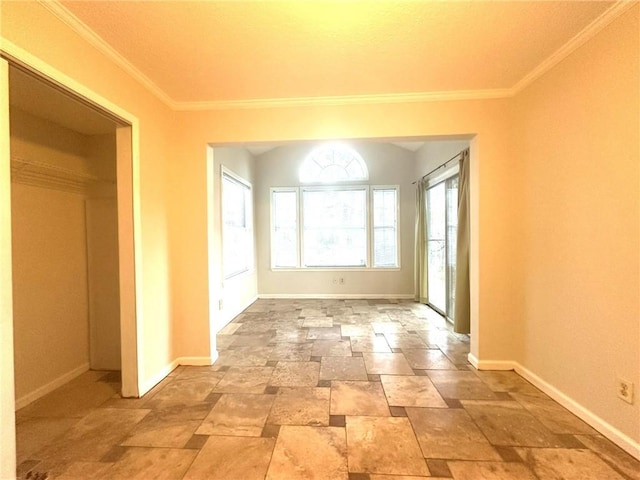 interior space featuring crown molding, stone finish flooring, and baseboards