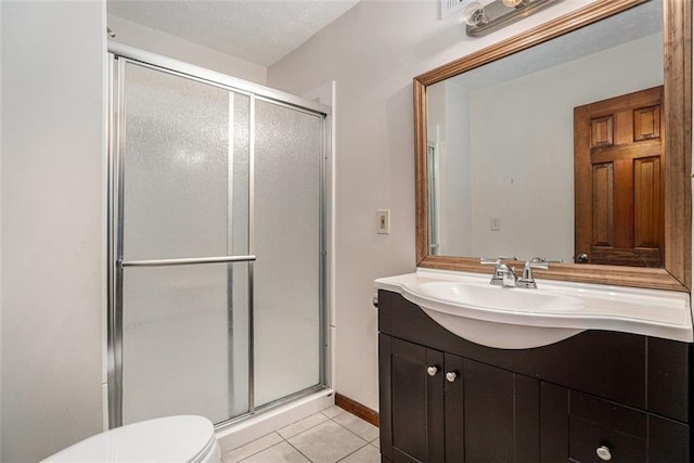 bathroom featuring a stall shower, baseboards, toilet, tile patterned floors, and vanity