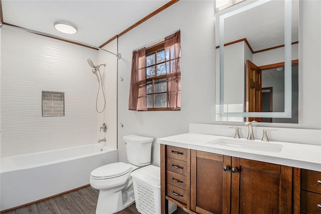 full bath with toilet, ornamental molding, wood finished floors, tub / shower combination, and vanity