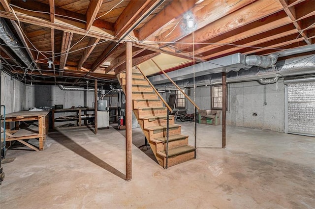 below grade area featuring water heater and stairway