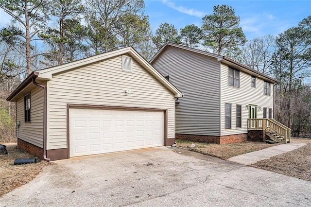 view of side of home with aphalt driveway and an attached garage