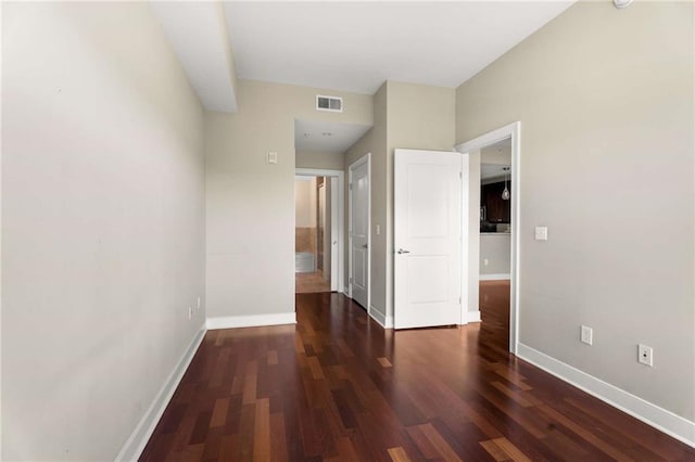 unfurnished bedroom with baseboards and wood finished floors