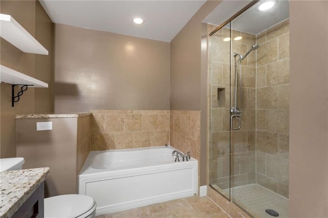 full bathroom featuring a garden tub, a shower stall, toilet, vanity, and recessed lighting