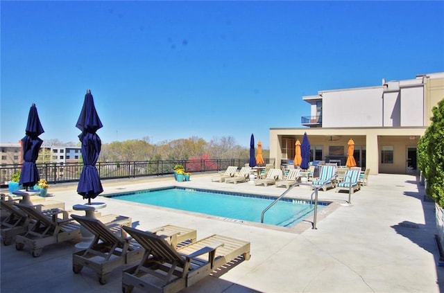 community pool featuring a patio area and fence