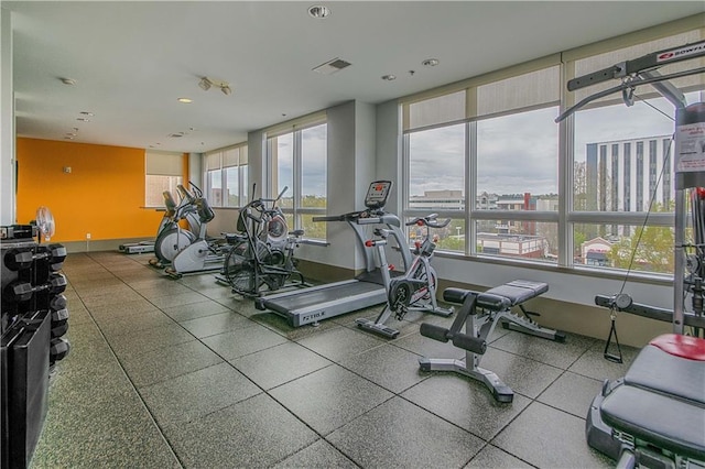 exercise room featuring baseboards and recessed lighting