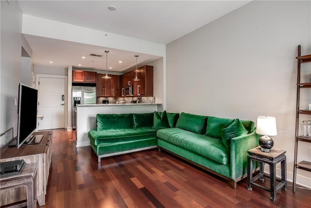 living area featuring dark wood finished floors, visible vents, and recessed lighting