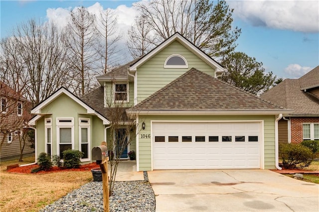 traditional-style home with a shingled roof, concrete driveway, and an attached garage