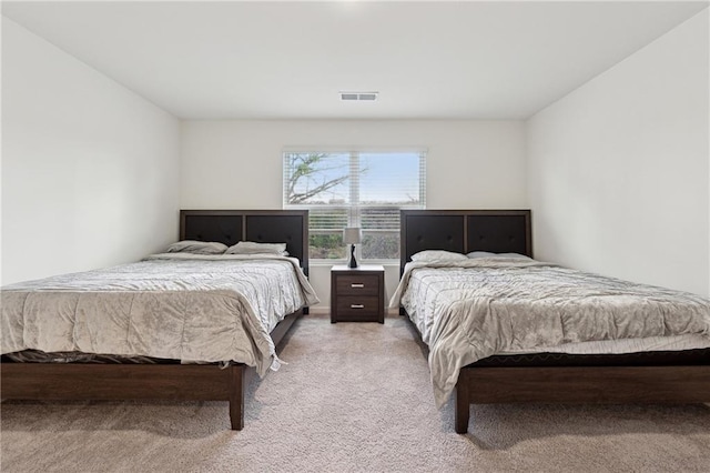 bedroom featuring light carpet