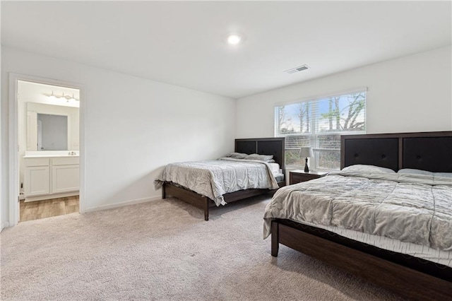 carpeted bedroom with connected bathroom