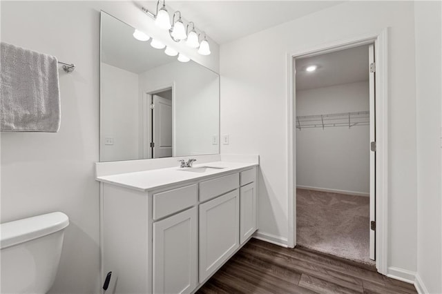 bathroom with vanity, wood-type flooring, and toilet