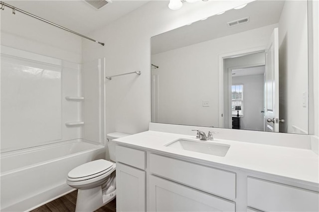 full bathroom featuring vanity, hardwood / wood-style flooring, toilet, and shower / bathtub combination