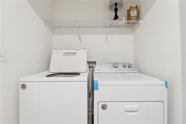 clothes washing area featuring separate washer and dryer