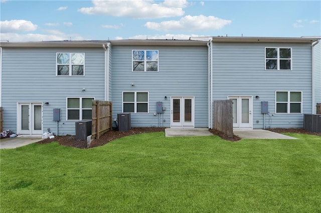 back of property featuring a lawn, central AC unit, and a patio