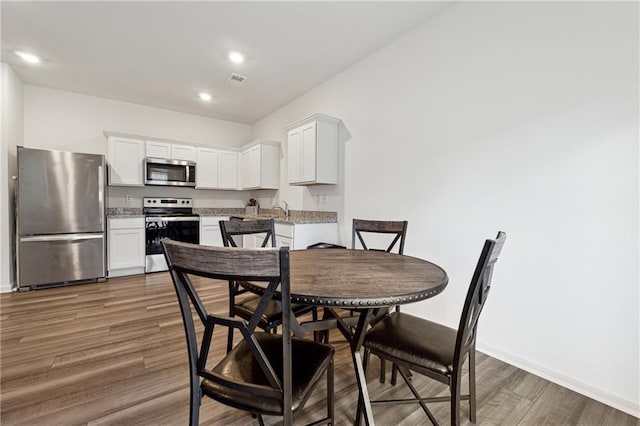 dining space featuring sink and dark hardwood / wood-style floors