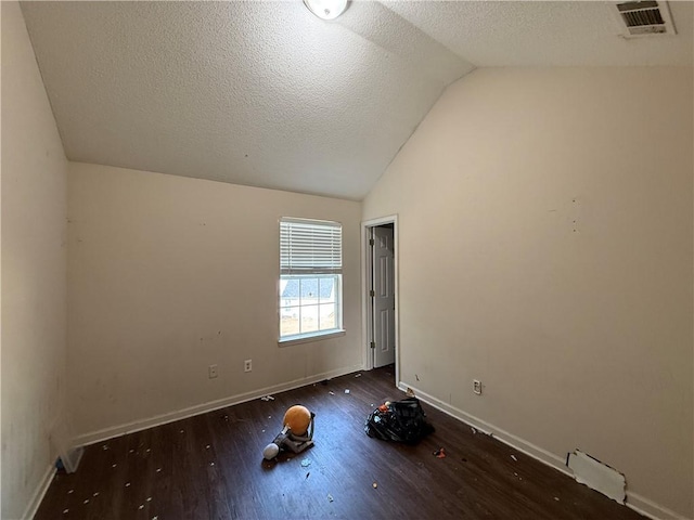 2625 Thunder Basin Way, Douglasville, GA 30135 - unfurnished room featuring visible vents, baseboards, a textured ceiling, wood finished floors, and lofted ceiling