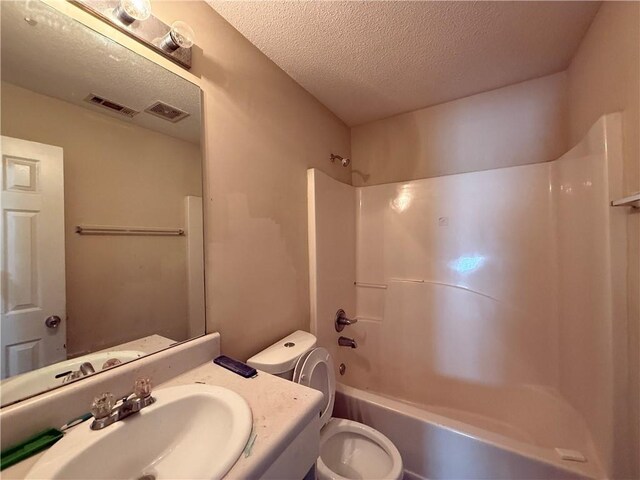 2625 Thunder Basin Way, Douglasville, GA 30135 - bathroom featuring toilet, a textured ceiling, washtub / shower combination, and visible vents