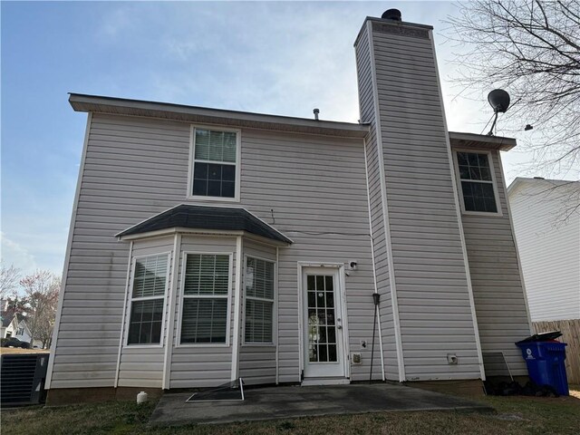 2625 Thunder Basin Way, Douglasville, GA 30135 - rear view of property featuring fence, central air condition unit, a patio, and a chimney