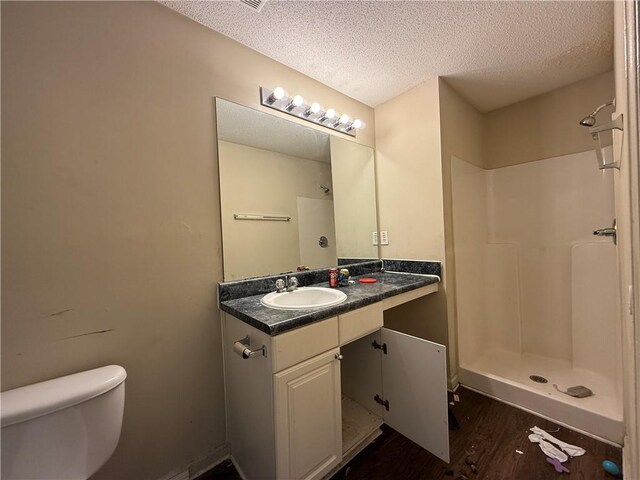 2625 Thunder Basin Way, Douglasville, GA 30135 - bathroom with toilet, a stall shower, wood finished floors, and a textured ceiling
