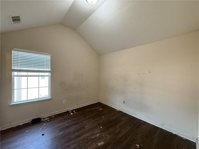 2625 Thunder Basin Way, Douglasville, GA 30135 - additional living space featuring a textured ceiling, visible vents, vaulted ceiling, wood finished floors, and baseboards