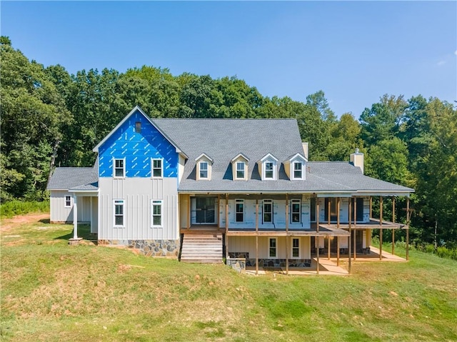 rear view of property featuring a yard