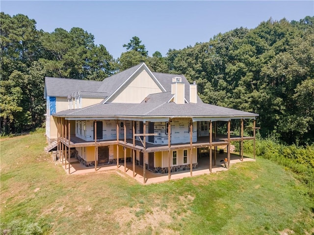 rear view of house with a yard, a patio area, and a wooden deck