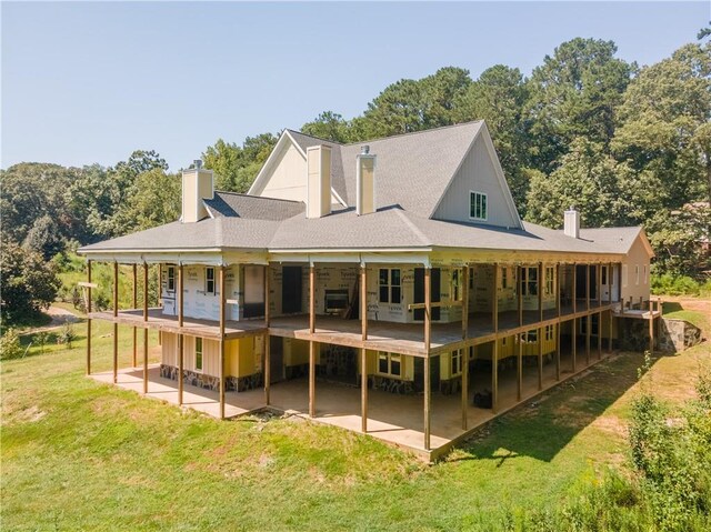 back of house featuring a lawn and a patio area